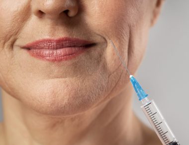 smiley-elder-woman-using-injection-for-her-mouth-wrinkles