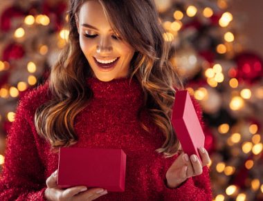 Beautiful girl sitting in a cozy atmosphere near the Christmas tree